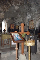 A peaceful chapel interior filled with icons of various Virgin Mary figures.