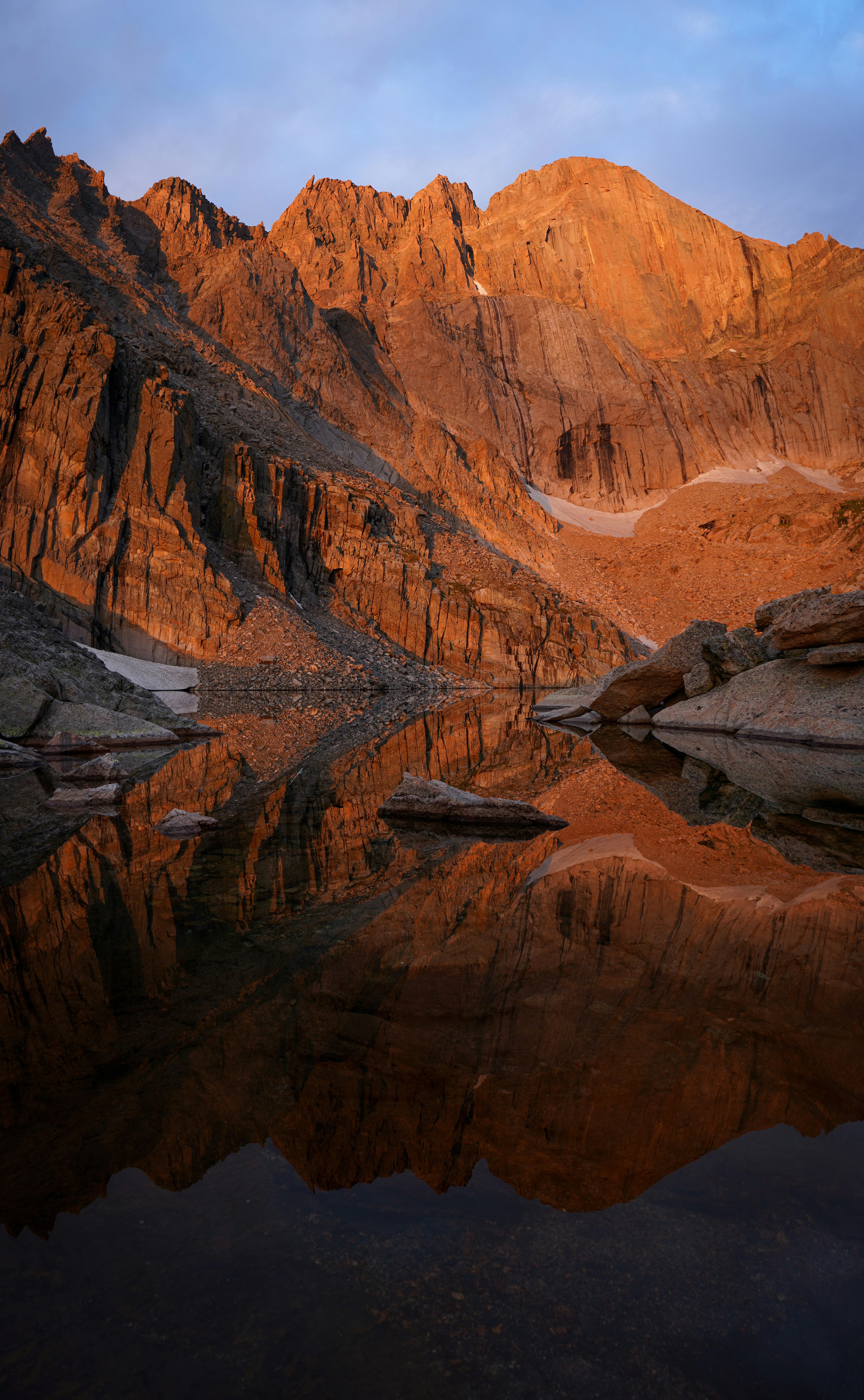 a mountain range with a lake in the foreground