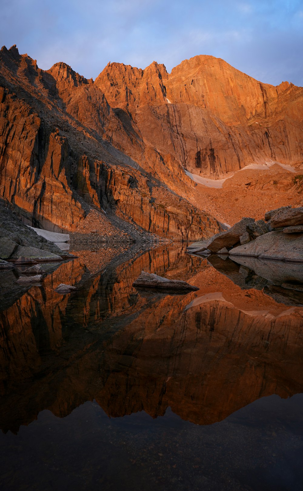 a mountain range with a lake in the foreground