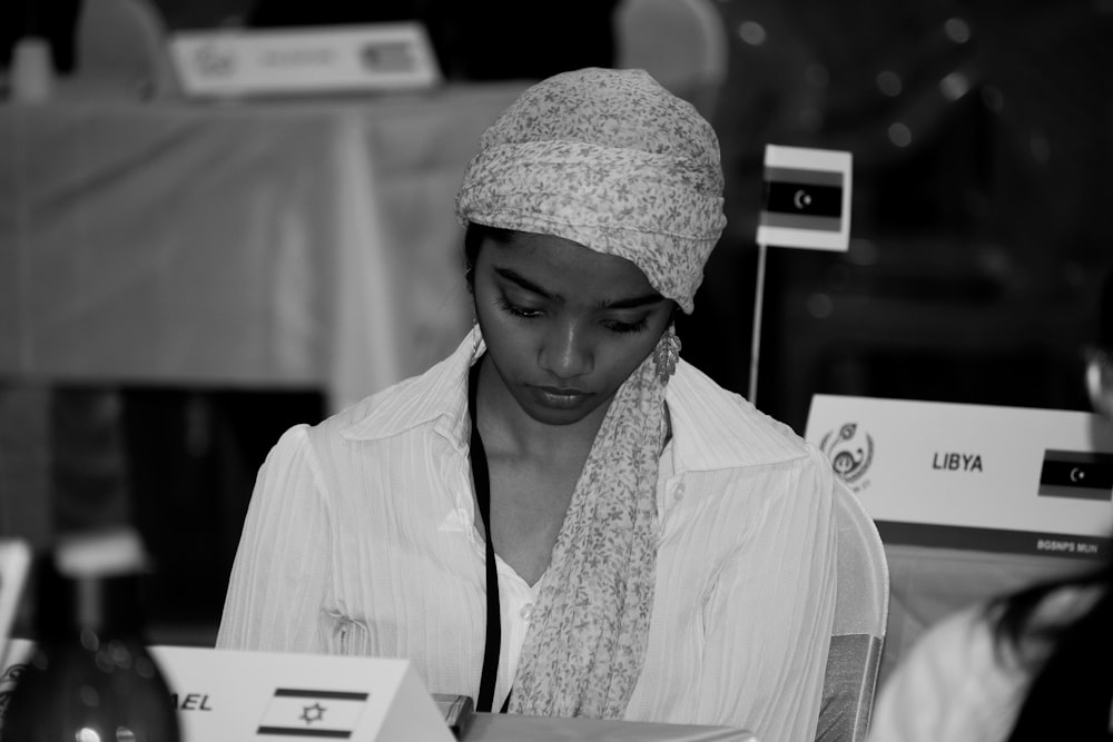 a woman wearing a head scarf and a scarf around her neck