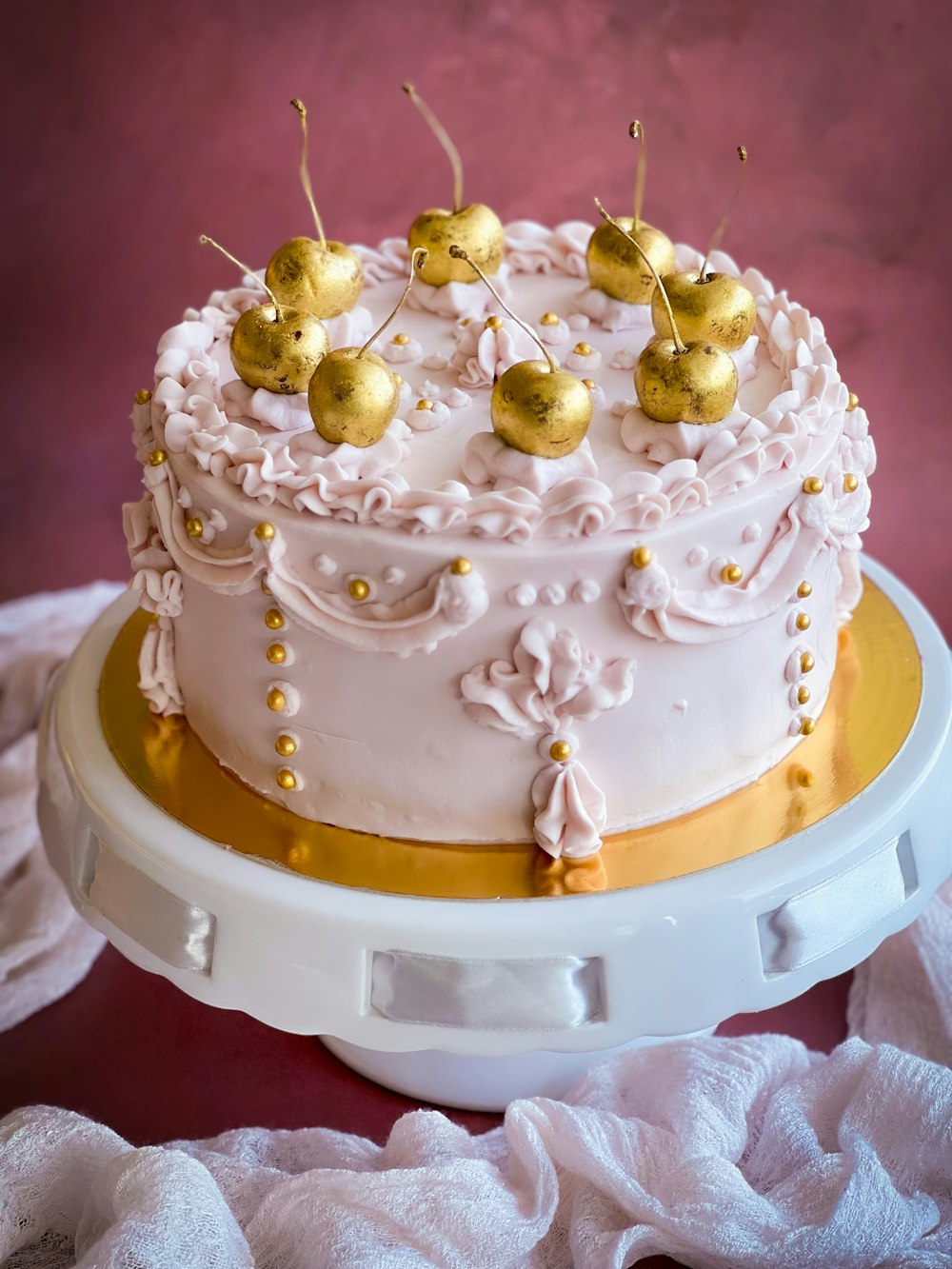 a white cake with gold decorations on top of it