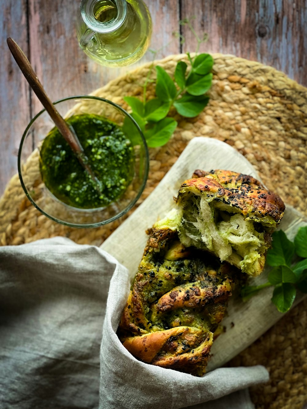 a plate of food with broccoli and a glass of pesto