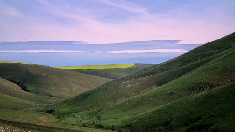 Scenic view of the Káli Basin landscape with rolling hills and clear skies