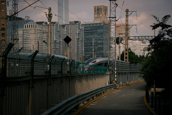 A sleek tram-train traveling through a vibrant urban landscape in Kinshasa.
