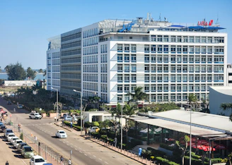 a large white building sitting on the side of a road