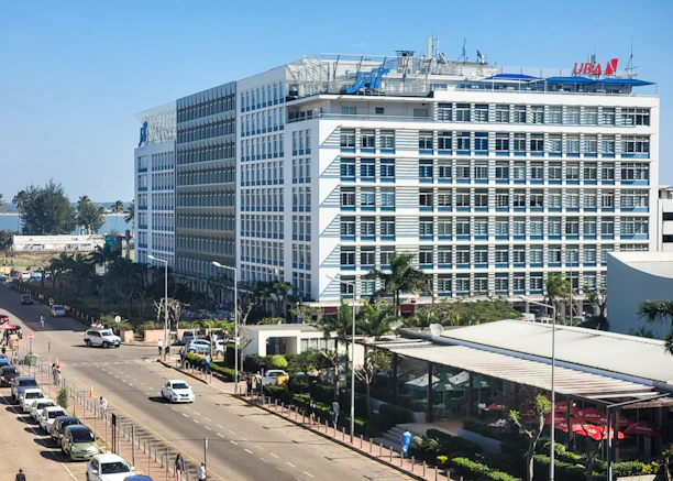 a large white building sitting on the side of a road
