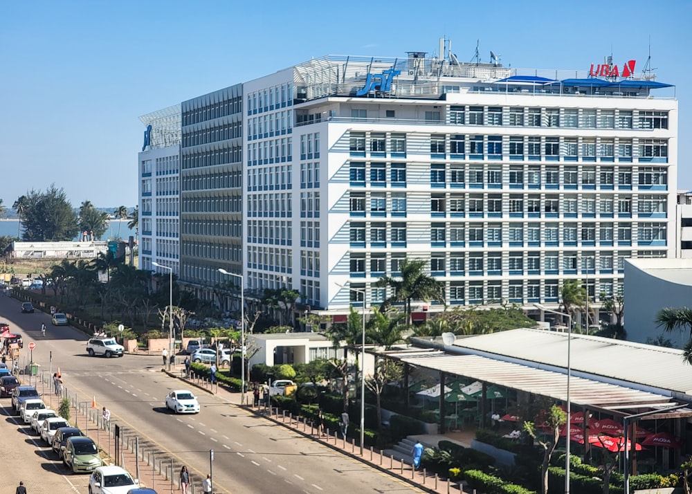 a large white building sitting on the side of a road