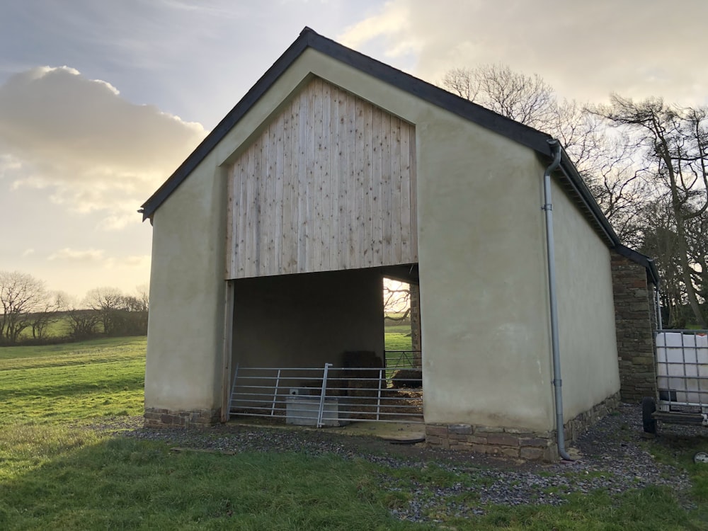 a barn with a gate in the middle of it