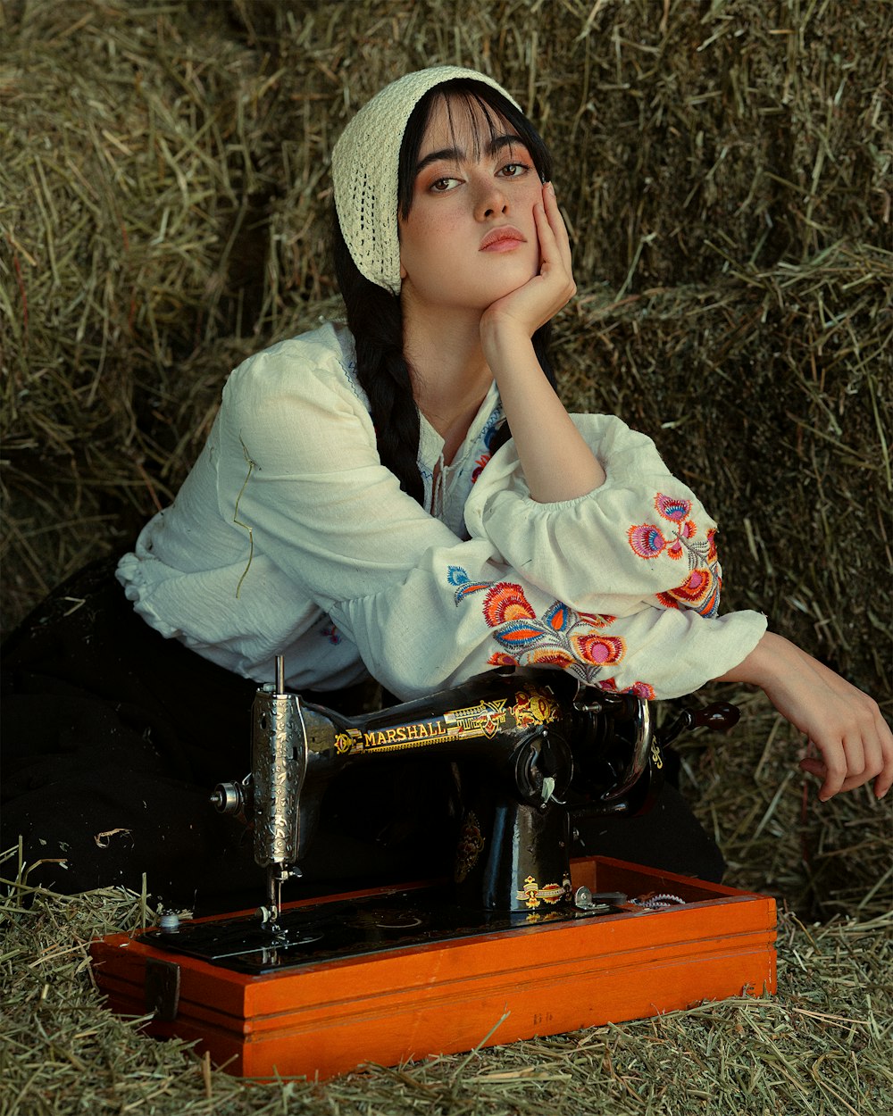 a woman sitting in front of a sewing machine