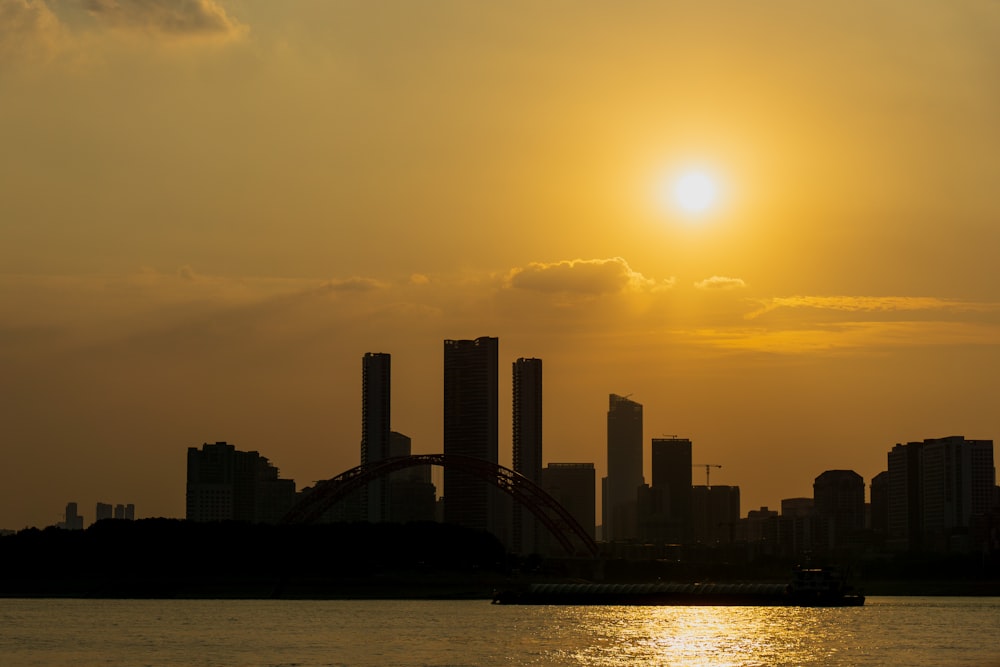 the sun is setting over the city skyline