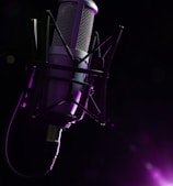 a microphone with a purple light behind it