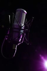 A variety of microphone stands displayed in a studio setting.