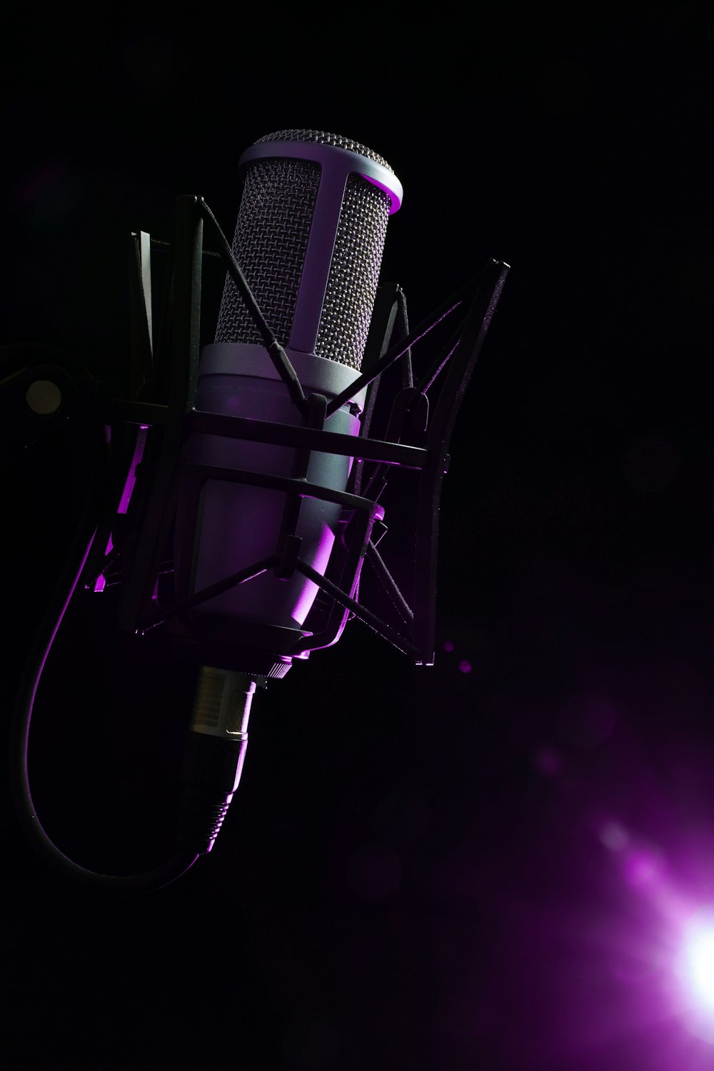 a microphone with a purple light behind it