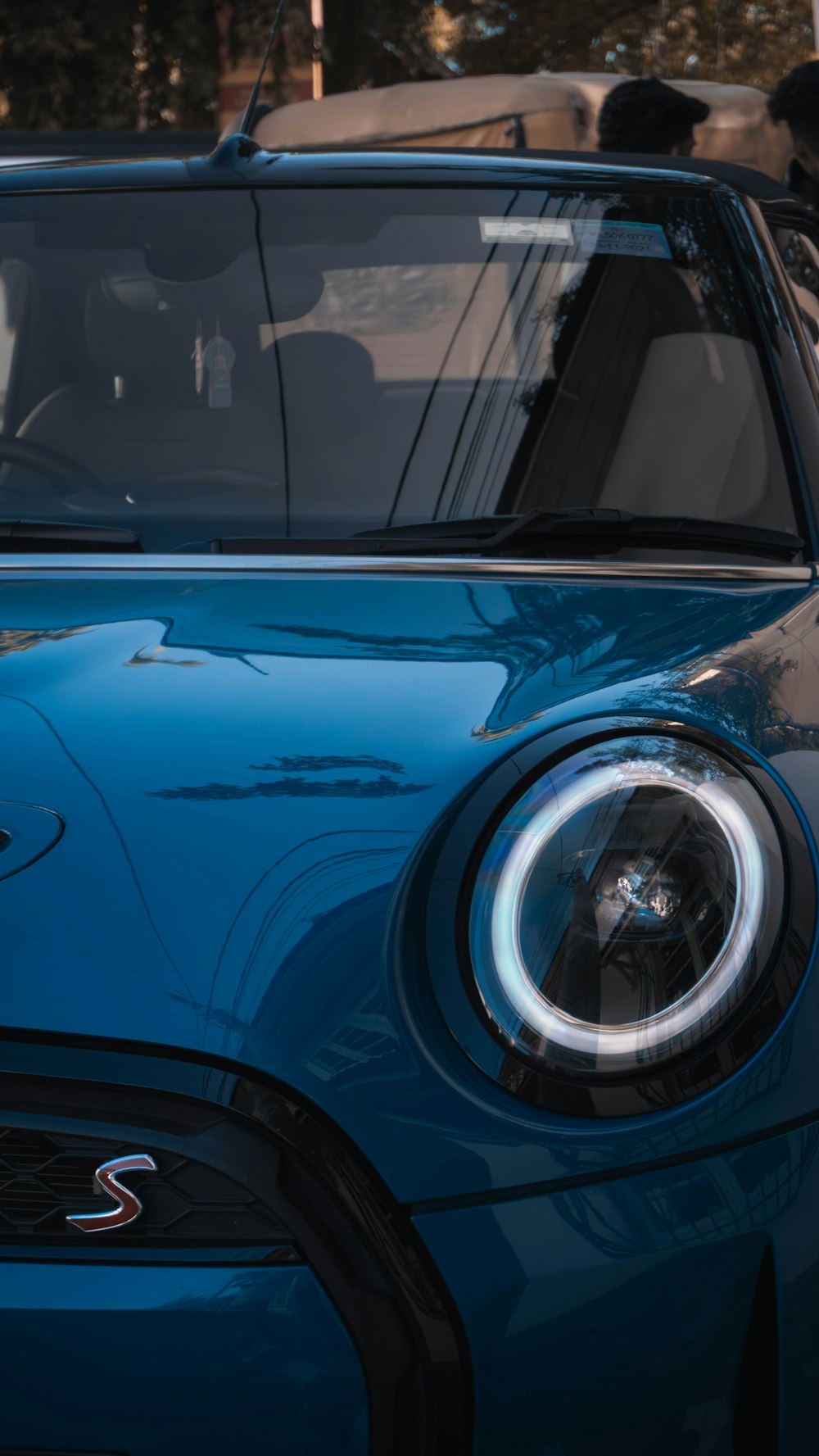 a close up of the front of a blue mini cooper cooper cooper cooper cooper cooper