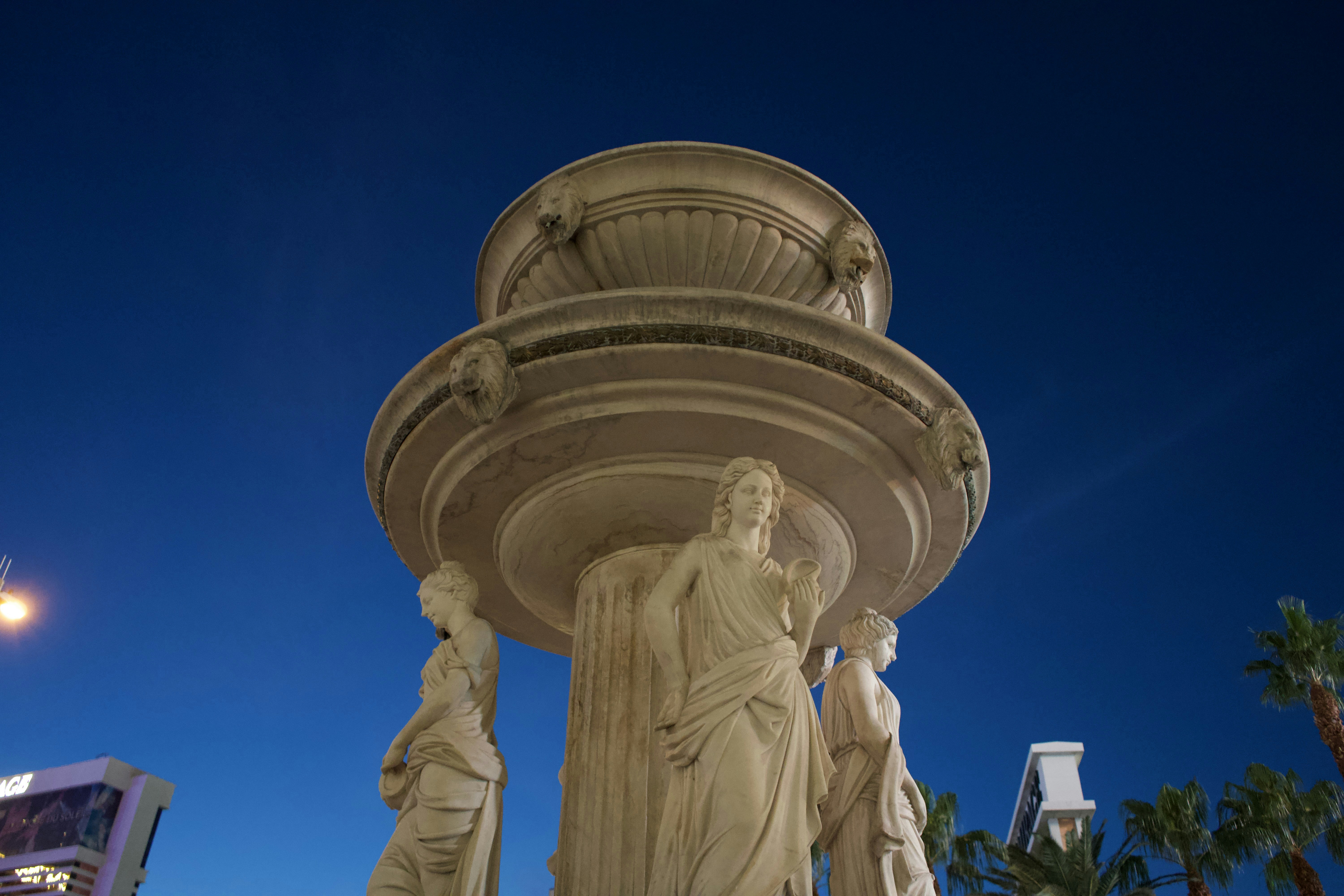 a fountain with statues of people around it