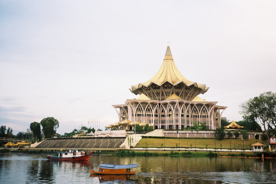Kuching waterfront with traditional boats and modern buildings