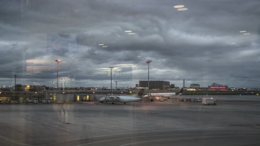 an airport tarmac with a plane parked on the tarmac