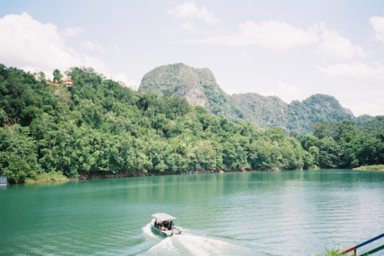 A scenic view of a boat on a tranquil lake.