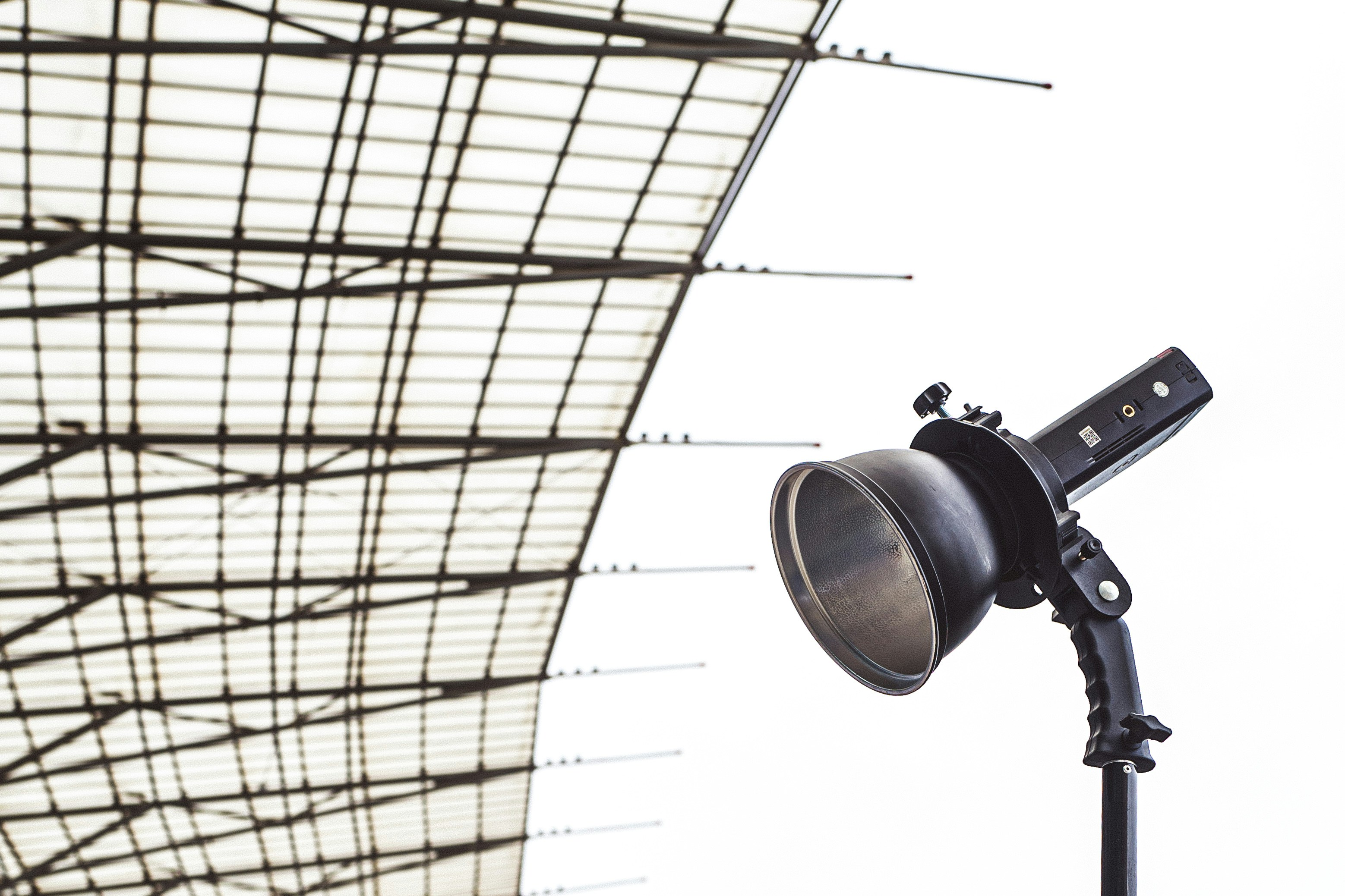a microphone on a tripod in front of a roof