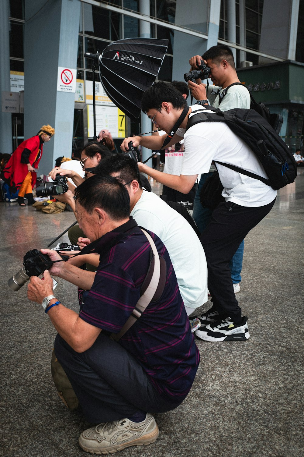 a man kneeling down while holding a camera