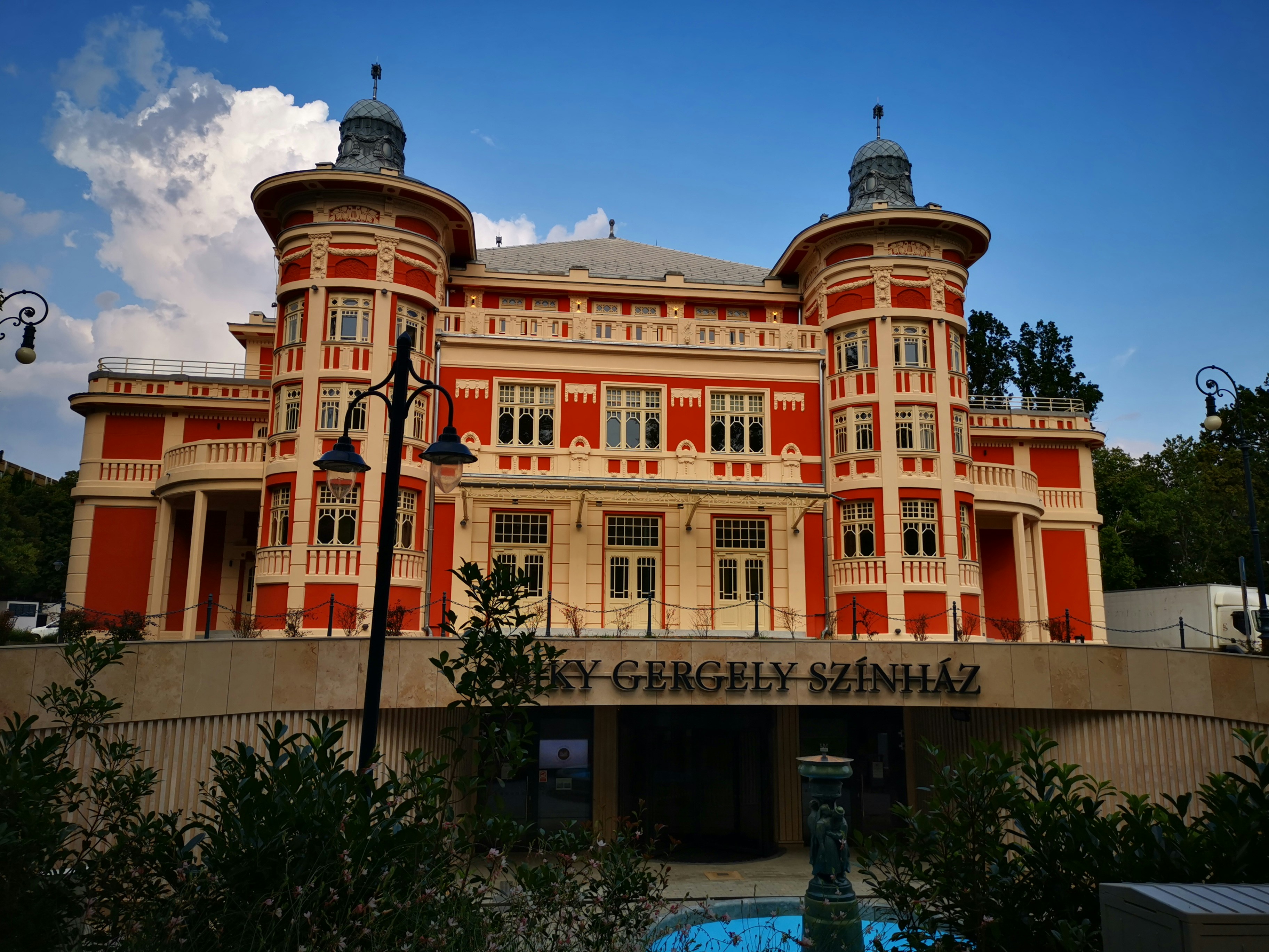 a large building with a fountain in front of it