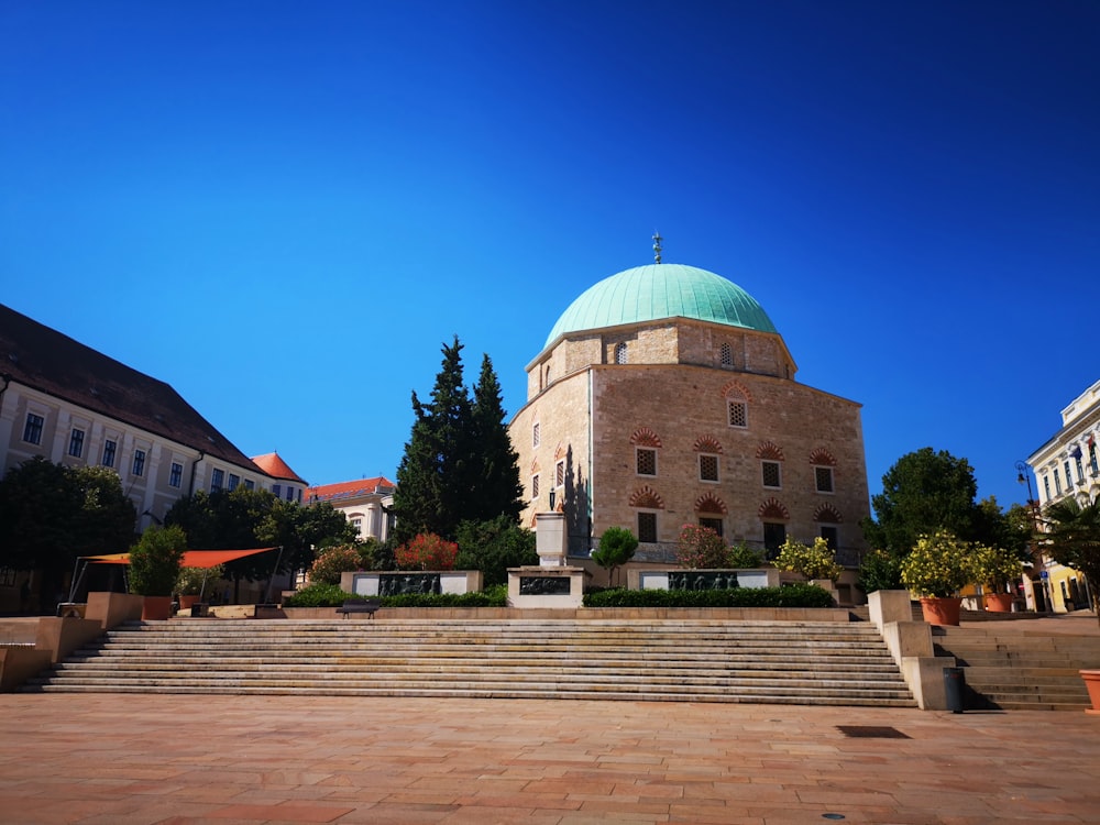 a large building with a green dome on top of it