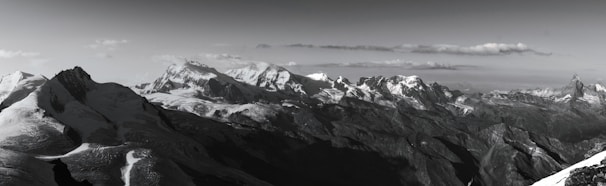 A panoramic view of the Himalayan quantum vaults nestled in snowy mountain terrain under a clear blue sky.