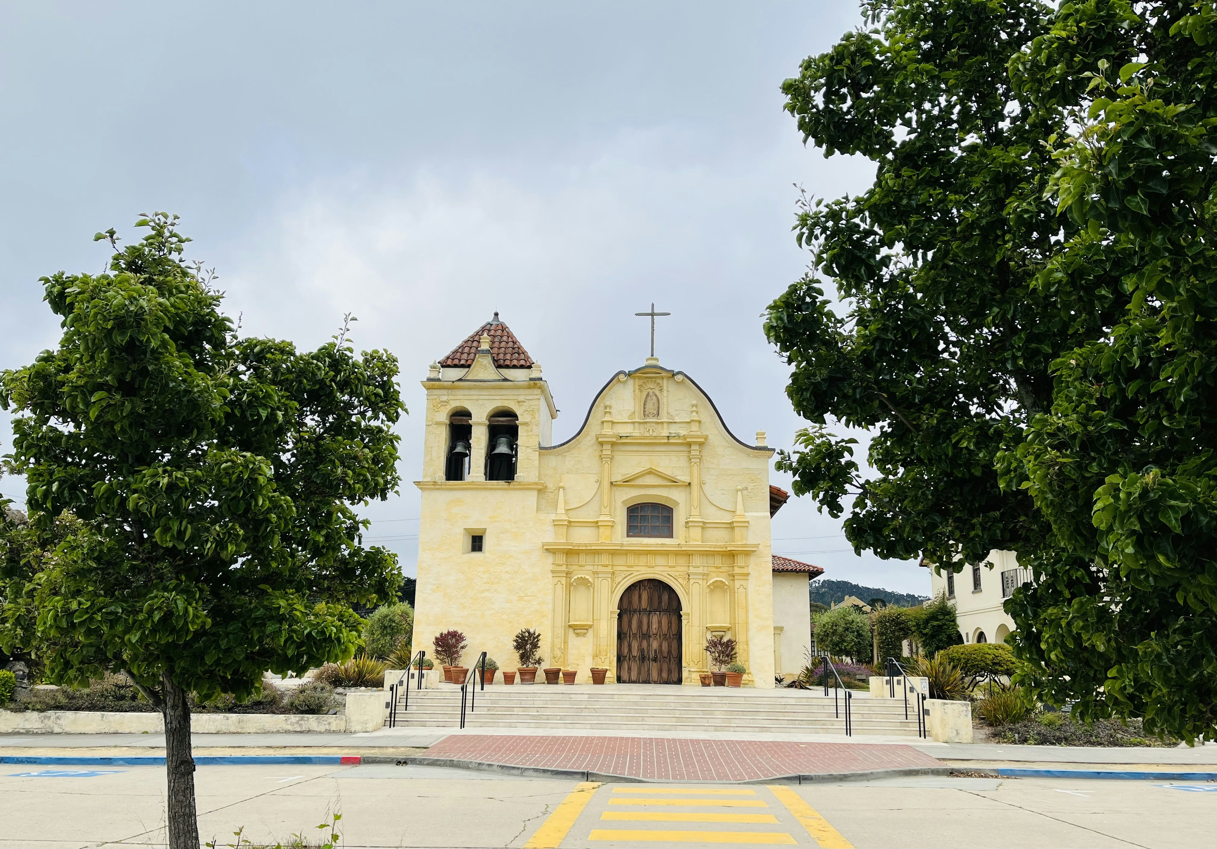 a yellow church with a cross on top of it