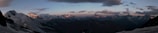 A panoramic shot of a mountain range at sunset.