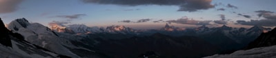 A panoramic shot of a mountain range at sunset.