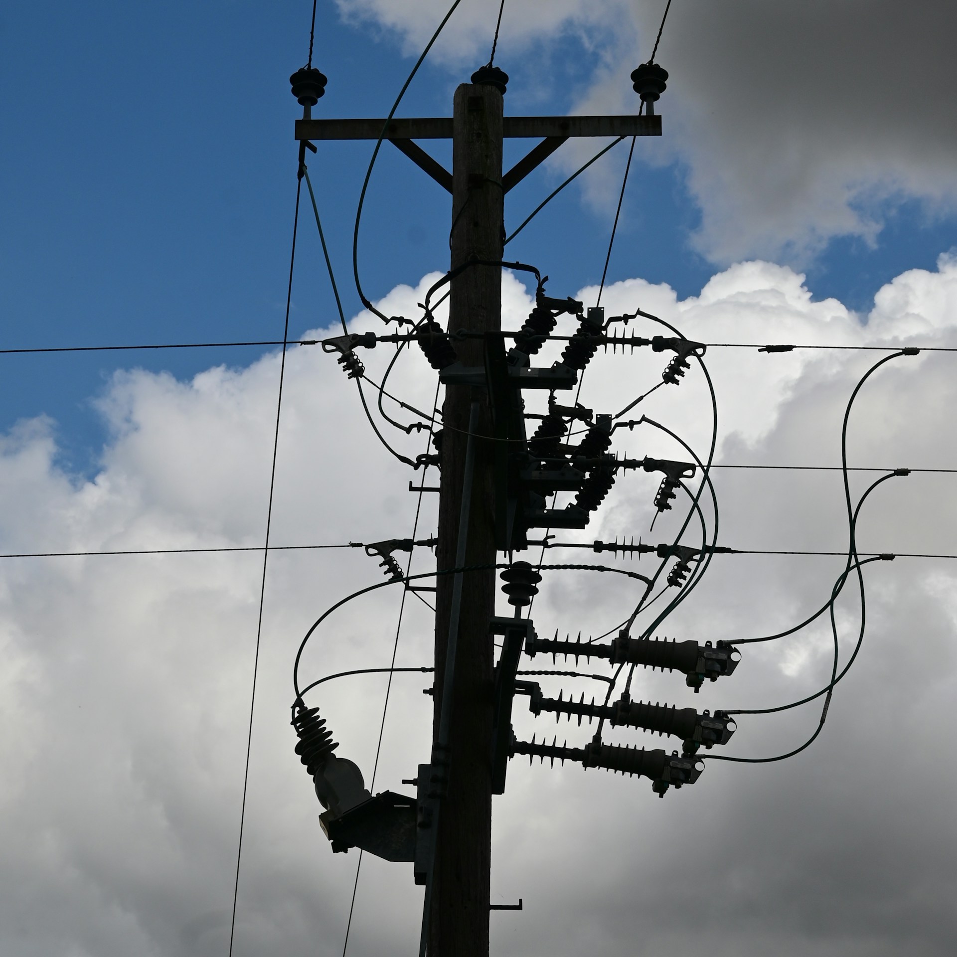 a telephone pole with a bunch of wires attached to it