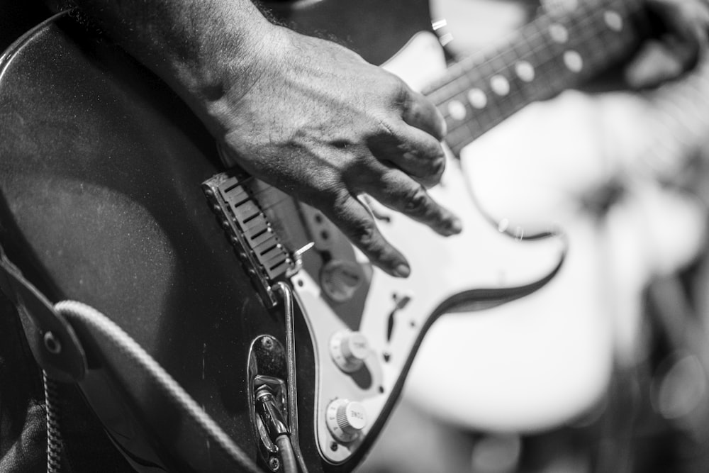 a close up of a person playing a guitar