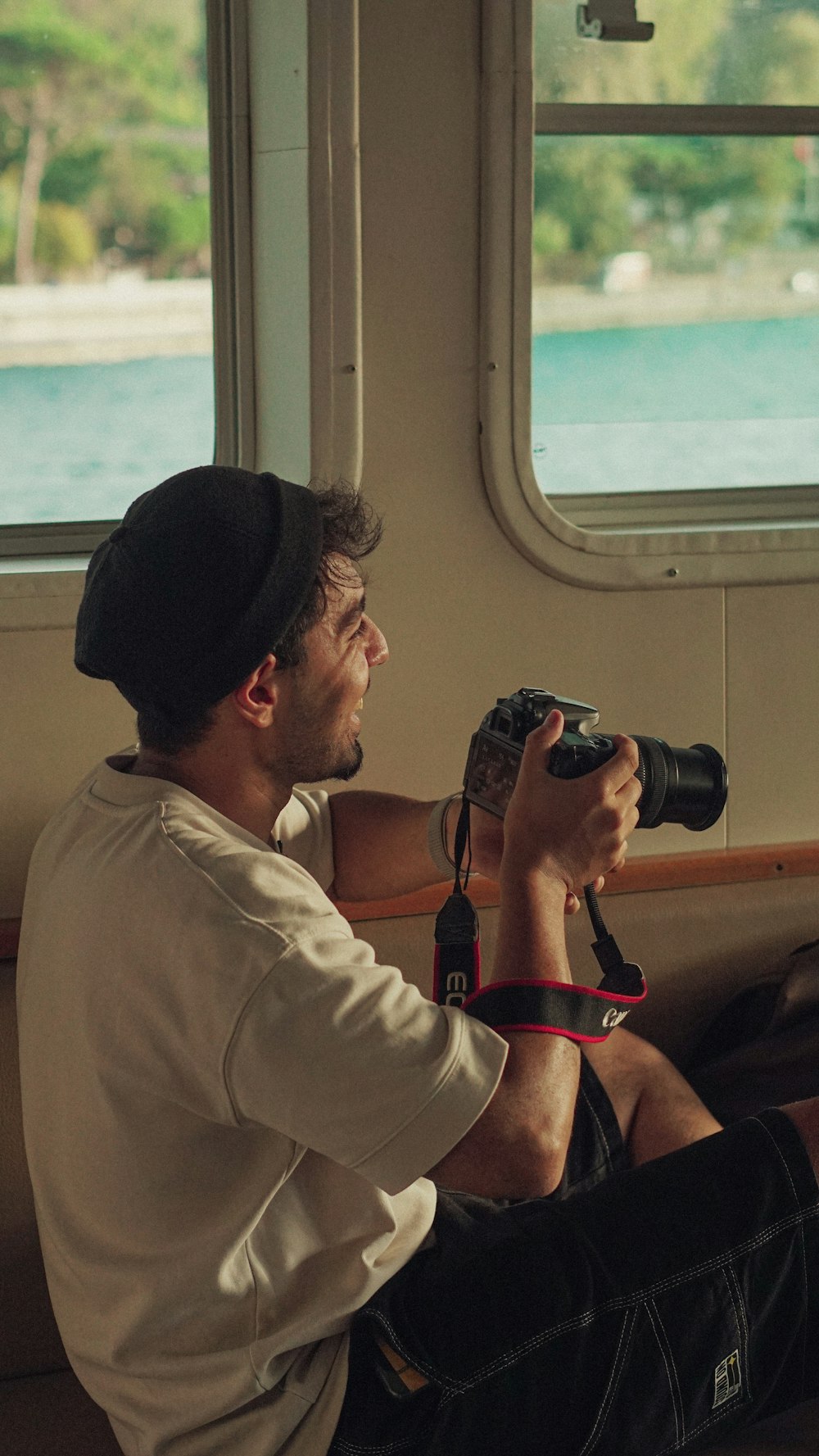 a man sitting on a boat holding a camera