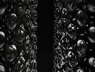 A close-up of intricate 3D-printed objects on a dark surface.