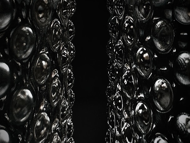 A close-up of intricate 3D-printed objects on a dark surface.