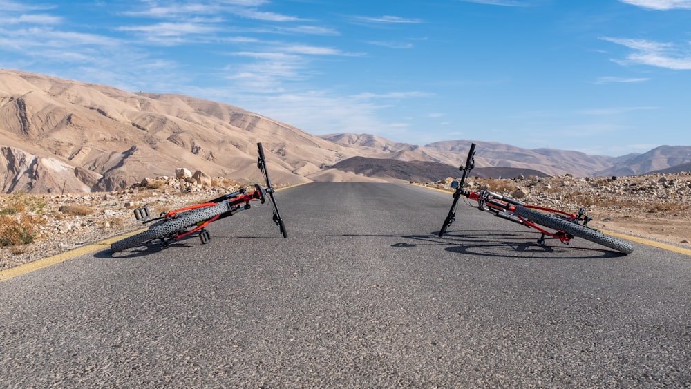 a pair of bikes sitting on the side of a road