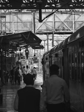 An image depicting a train station with travelers.