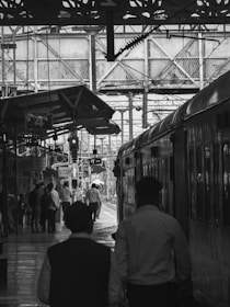 An image depicting a train station with travelers.