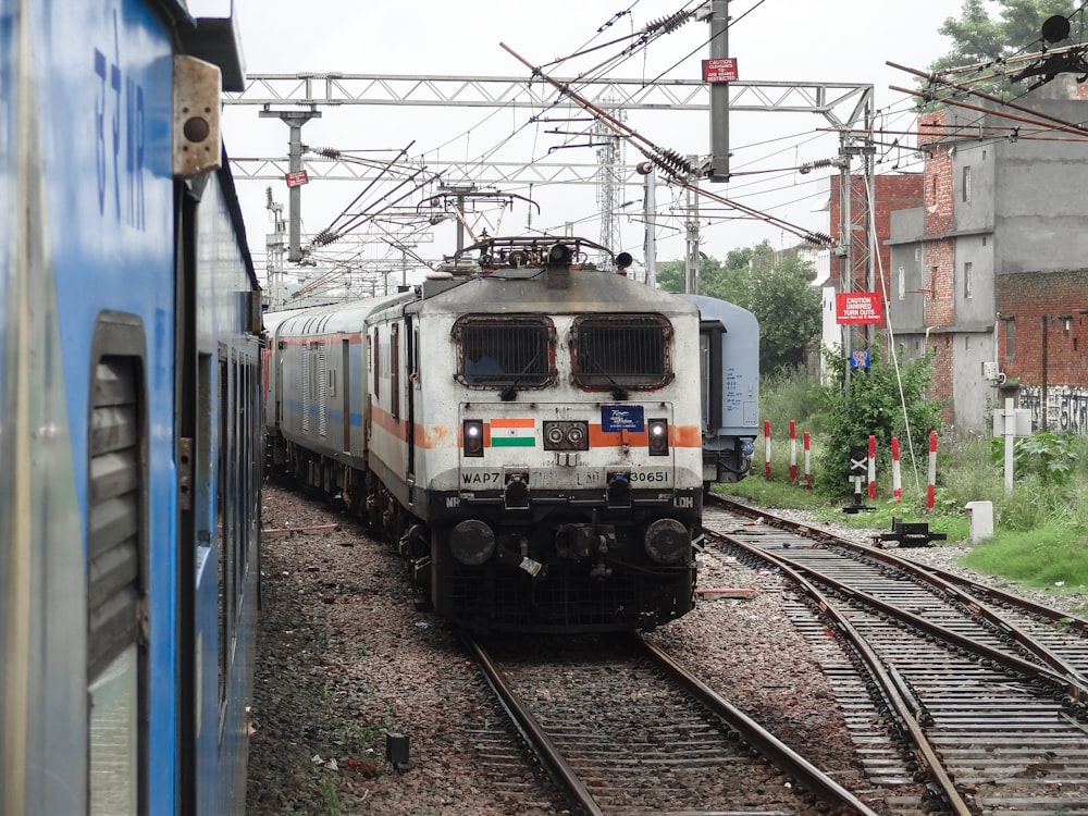 a train traveling down train tracks next to a building