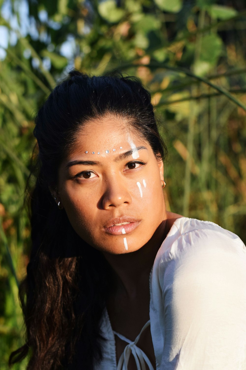 a woman with white paint on her face