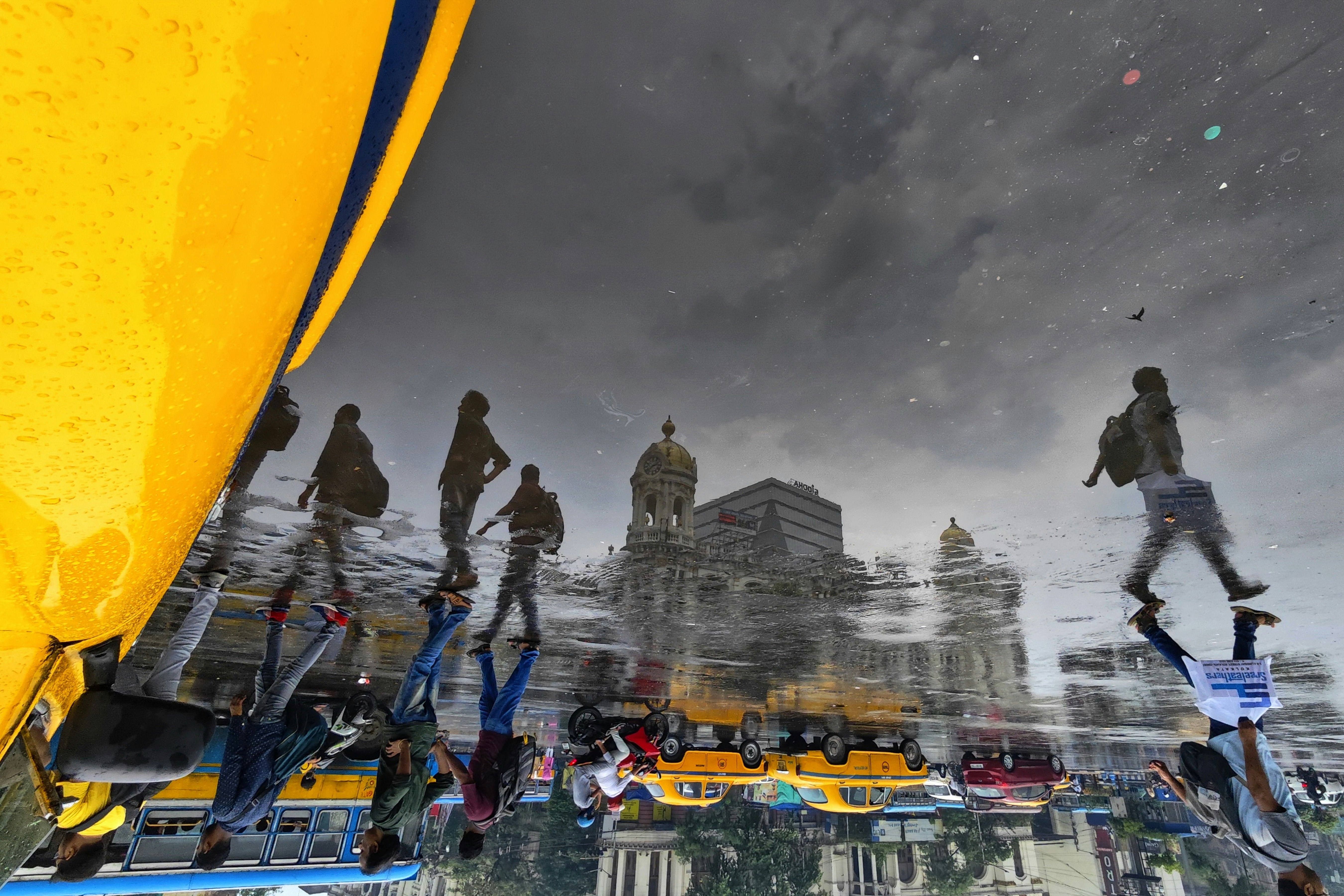 a group of people standing on top of a boat under a cloudy sky, 