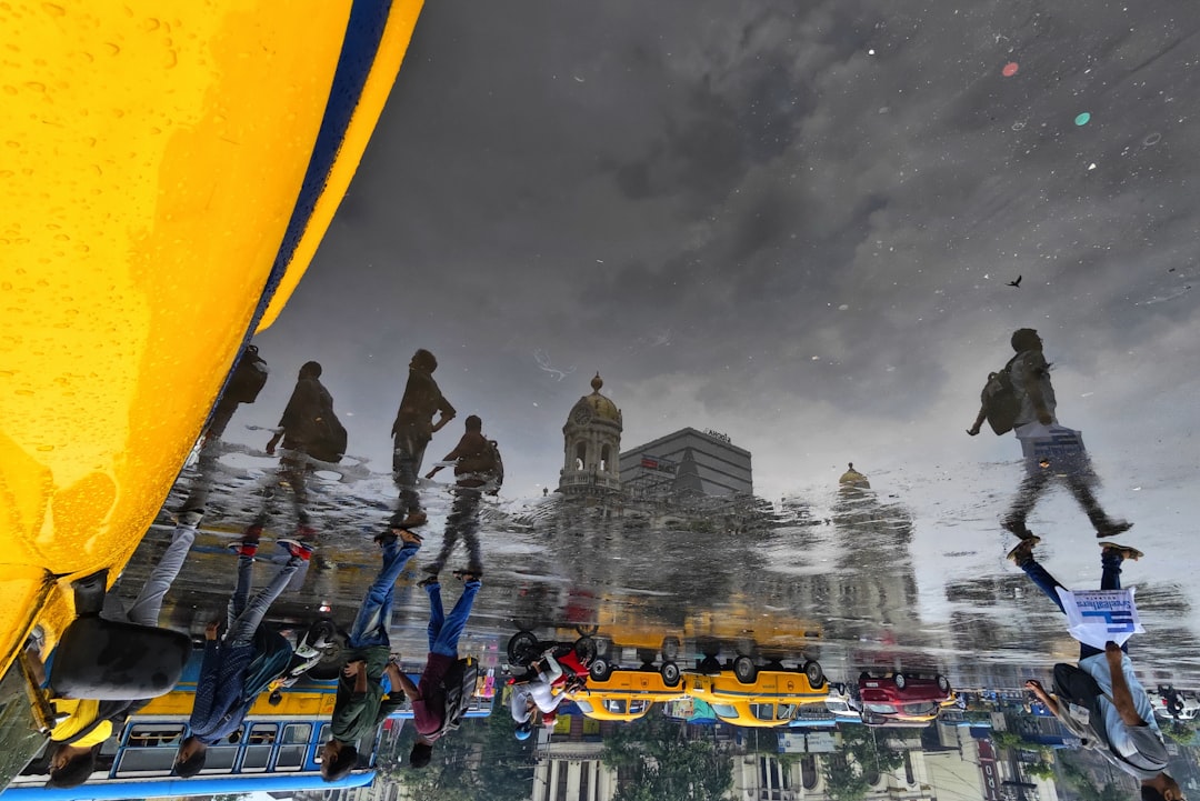 a group of people standing on top of a boat under a cloudy sky,