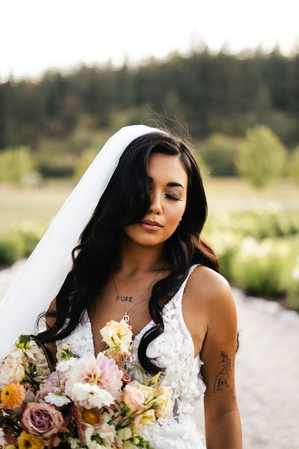 a woman in a wedding dress holding a bouquet of flowers