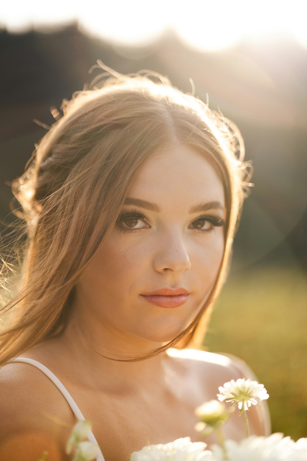 a beautiful young woman holding a bouquet of flowers