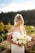 a woman in a white dress holding a bouquet of flowers