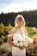 a woman in a white dress holding a bouquet of flowers