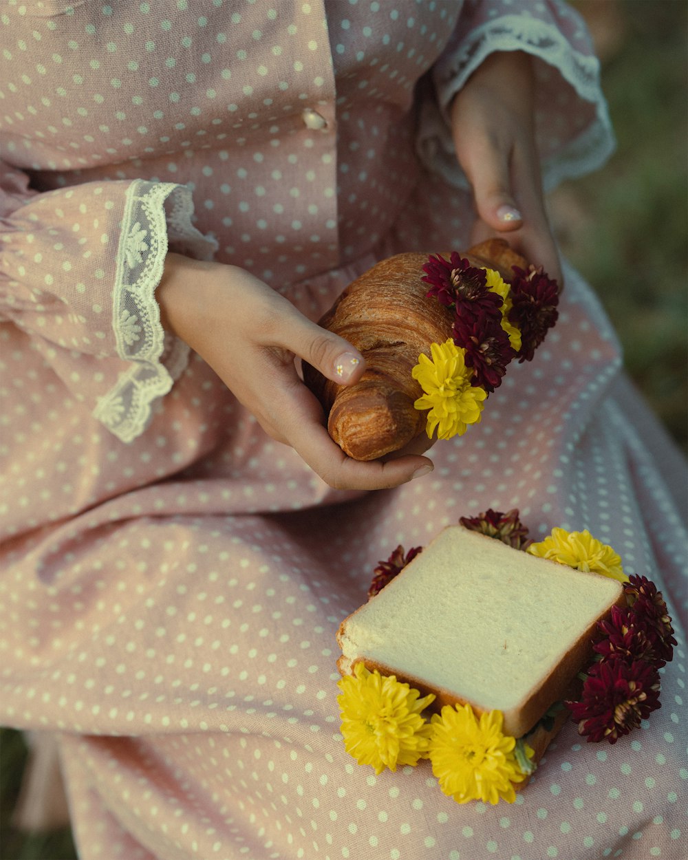 a doll holding a piece of bread and flowers