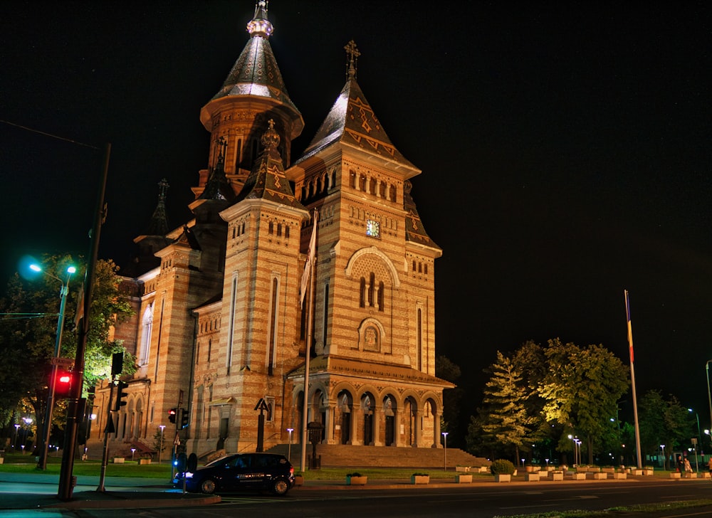 a large church with a clock tower at night