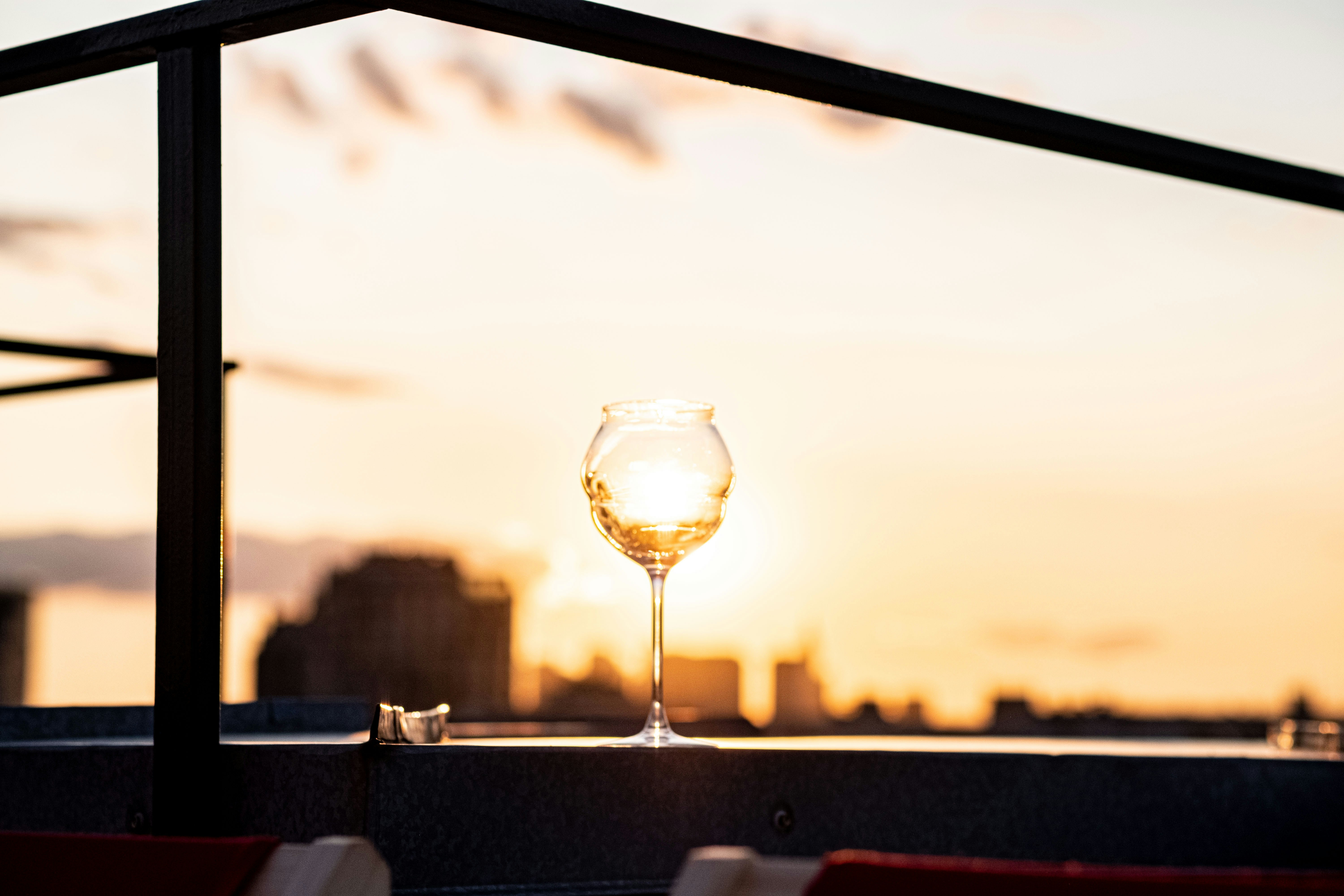 a glass of wine sitting on top of a table, 