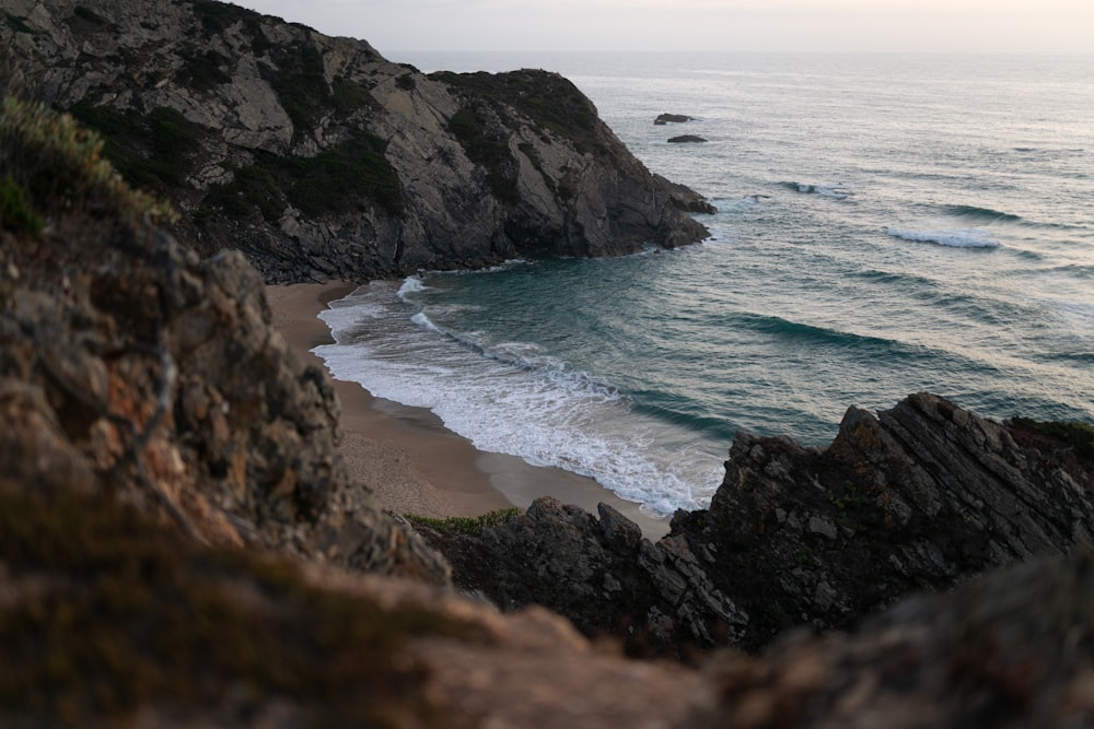 a view of the ocean from a rocky cliff